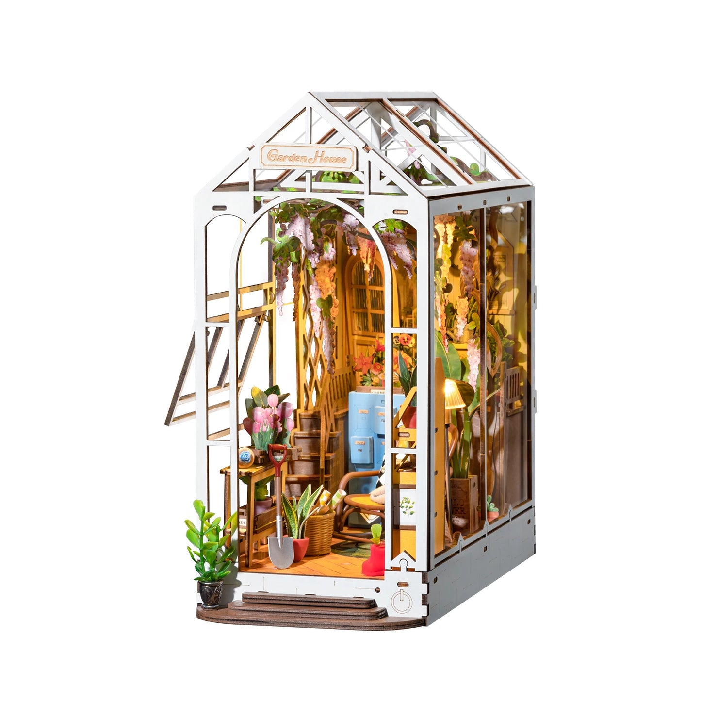 Model of a miniature greenhouse with interior details on a white background
