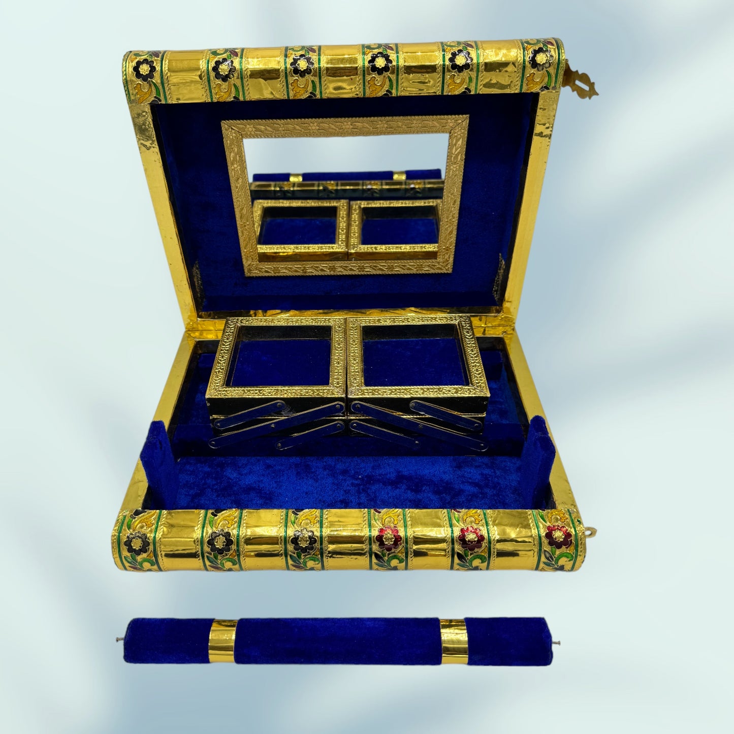 Open box reveals royal blue velvet lining with a lock on the side and a removable dowel. this photo shows the box with the trays folded down
